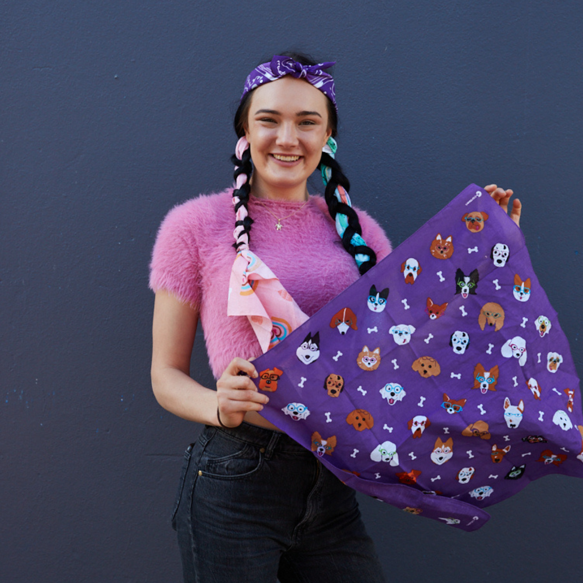 A young person holding a Bandanna Day bandanna